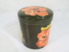 Moorcroft Pottery - A round lidded pot by Moorcroft pottery in the coral hibiscus pattern on a