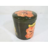 Moorcroft Pottery - A round lidded pot by Moorcroft pottery in the coral hibiscus pattern on a