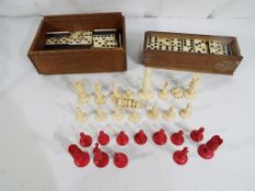 A quantity of ivory chess pieces and two boxes containing vintage dominoes - This lot MUST be paid