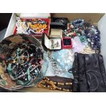 A large mixed lot of costume jewellery to include necklaces, bracelets,