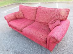 A good quality two seater fabric sofa in burgundy,