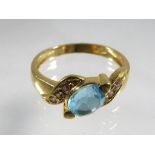 A lady's 18 carat yellow gold ring set with diamond and topaz stones, approximate weight 3.8 grams.