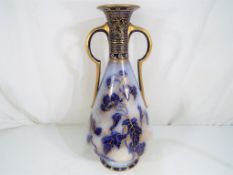 Doulton Burslem - A large Doulton Burslem twin handled conical form vase decorated with blue,