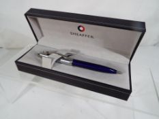 Sheaffer - a cased ball pen with indigo barrel by Sheaffer - This lot MUST be paid for and