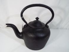A cast iron kettle, approximate height 27 cm (h).