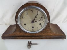 A good quality oak cased Napoleon hat mantel clock, Arabic numerals to a silvered dial,