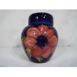 Moorcroft Pottery - A small Moorcroft pottery ginger jar in the anemone pattern on a blue ground,