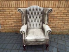 A good quality Chesterfield wing back armchair Est £100 - £200