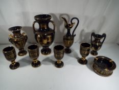 Nine pieces of ceramics by Spyropoulos in black and 24 K gold decoration featuring Greek key and