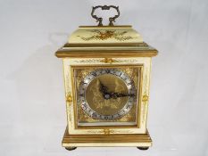 A mantel clock in the style of an early English bracket clock by Elliotts of London,