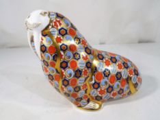 Royal Crown Derby - a Royal Crown Derby paperweight depicting a walrus with silver stopper.
