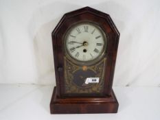 An American mantel clock, Roman numerals to the white dial, with pendulum and key,