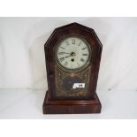 An American mantel clock, Roman numerals to the white dial, with pendulum and key,