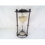 A good quality hourglass, approximate height 32 cm.