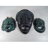 Three Terracotta painted wall masks, largest 22 cm x 17 cm.