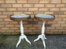 A pair of painted mahogany French ormolu mounted tripod wine tables having marble insert tops,