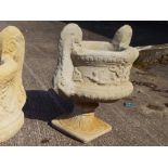 A large twin handled stone urn,