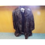 A good quality fur coat by Simpsons, dark brown with slip pockets, approximately 108 cm (l).