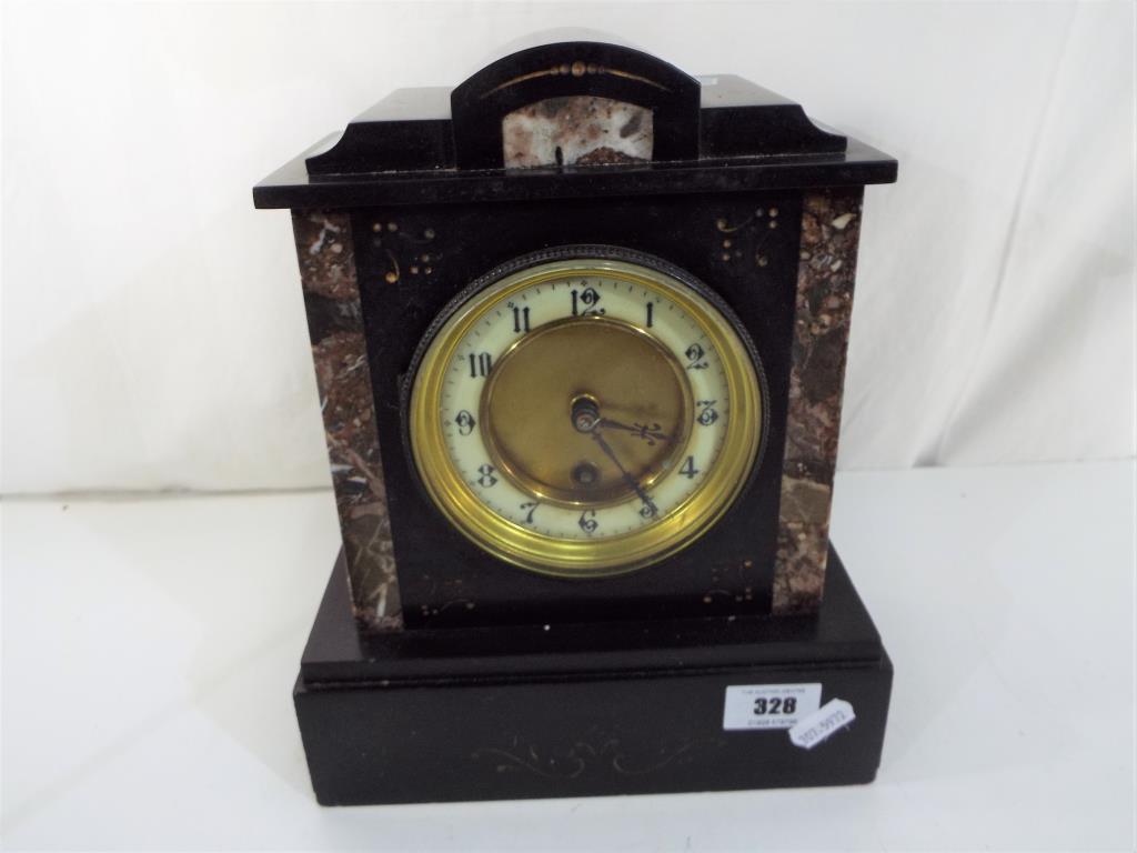 A French black marble mantel clock, opening bezel over whit enamel chapter ring with brass centre,