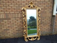 An ornate gilded French wall mirror,
