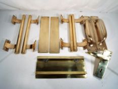 A large collection of good quality solid brass door furniture to include pull handles,