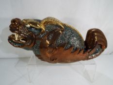 A large ceramic model depicting a dragon,