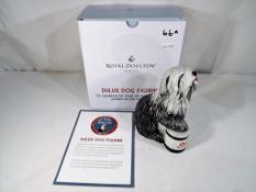 Royal Doulton - a Royal Doulton figurine entitled The Dulux Dog celebrating 50 years of Dulux,