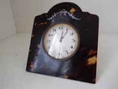 An Arts and Crafts Tortoiseshell framed, easel backed 8-day desk clock,