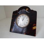 An Arts and Crafts Tortoiseshell framed, easel backed 8-day desk clock,