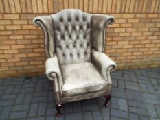 A good quality Chesterfield wing back armchair Est £100 - £200
