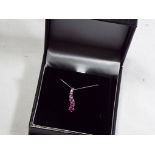 A 9 carat white gold pink sapphire drop pendant, approx 1.