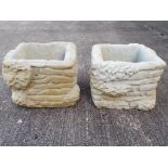 Two large stone square brick style planters festooned with ivy,