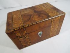 A 19th century crossbanded burr walnut twin-division tea caddy with mahogany square lids,