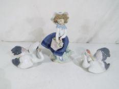 Lladro - Three figurines by Lladro to include a girl carrying a basket of flowers and two models of
