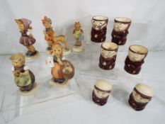 Five Goebel Hummel figurines and a set of egg cups and cruets by Weiss