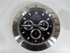 A decorative advertising wall clock in the style of a Rolex wristwatch,