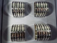 Wedgwood - a set of white metal Wedgwood Vera Wang napkin rings in original box.