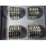 Wedgwood - a set of white metal Wedgwood Vera Wang napkin rings in original box.