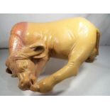 A highly carved soapstone figure depicting a buffalo,