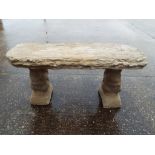 A stone bench with pillars in the form of squirrels,