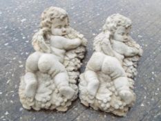 A pair of stone Baccus cherubs lying on a bed of grapes (2) Est £10 - £20