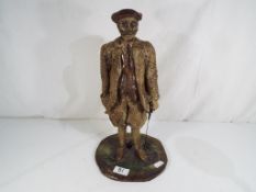 A good quality ceramic figurine depicting a early golfer.