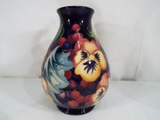 Moorcroft - a good quality Moorcroft vase decorated in the Fruit Feast pattern,