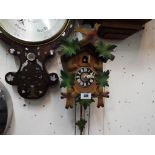 A wall mounted Cuckoo Clock, the case carved with oak leaves,