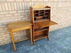 A compact oak fall front bureau with pigeon hole fitted interior 122 cm (h) x 58 cm x 23 cm and a
