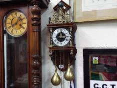 A Dutch Zaanse wall clock, bell striking movement with two brass pear-shaped weights,