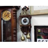 A Dutch Zaanse wall clock, bell striking movement with two brass pear-shaped weights,