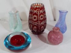 Five pieces of glassware to include a cranberry to clear vase,