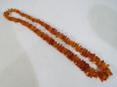 Amber - a graduated Baltic amber beaded necklace, approx 72cm overall length,