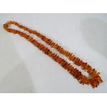 Amber - a graduated Baltic amber beaded necklace, approx 72cm overall length,